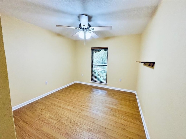 unfurnished room with light wood-type flooring, ceiling fan, and a textured ceiling