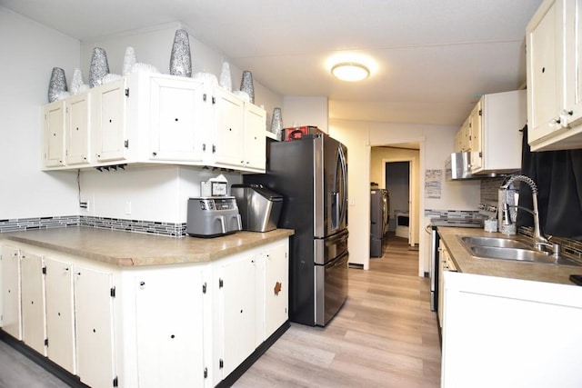 kitchen with appliances with stainless steel finishes, white cabinetry, and sink