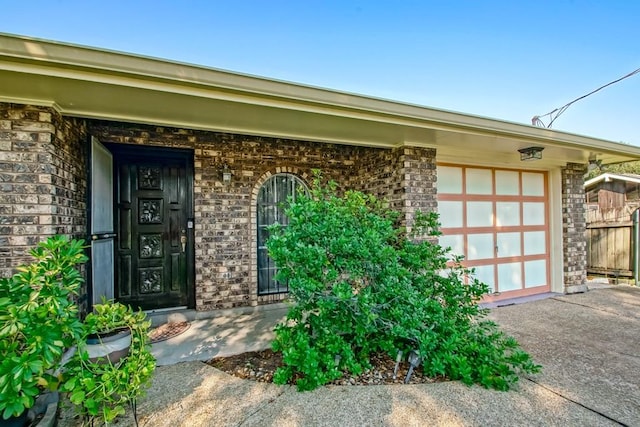 doorway to property with a garage