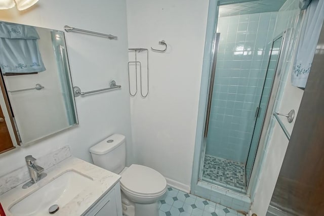 bathroom featuring toilet, walk in shower, and vanity