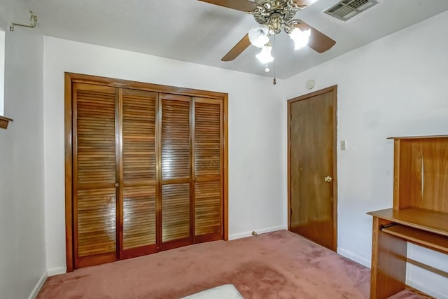 unfurnished bedroom featuring a closet, ceiling fan, and light carpet