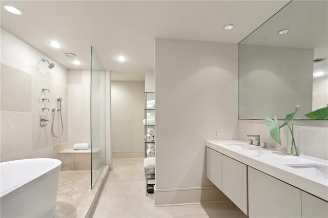 bathroom with separate shower and tub, vanity, and tile patterned floors