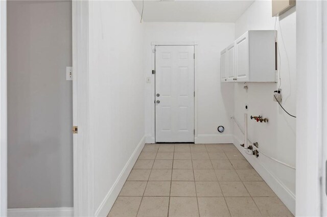 laundry room with washer hookup, hookup for a gas dryer, light tile patterned floors, and cabinets