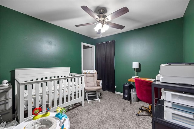 carpeted bedroom with a nursery area and ceiling fan