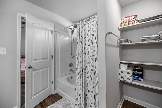 bathroom featuring wood-type flooring and shower / bath combo