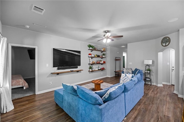 living room featuring dark hardwood / wood-style floors and ceiling fan