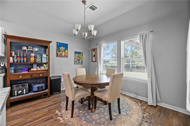 dining area featuring a chandelier and hardwood / wood-style floors