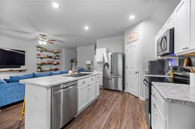 kitchen featuring a kitchen island with sink, dark hardwood / wood-style flooring, sink, stainless steel appliances, and white cabinetry