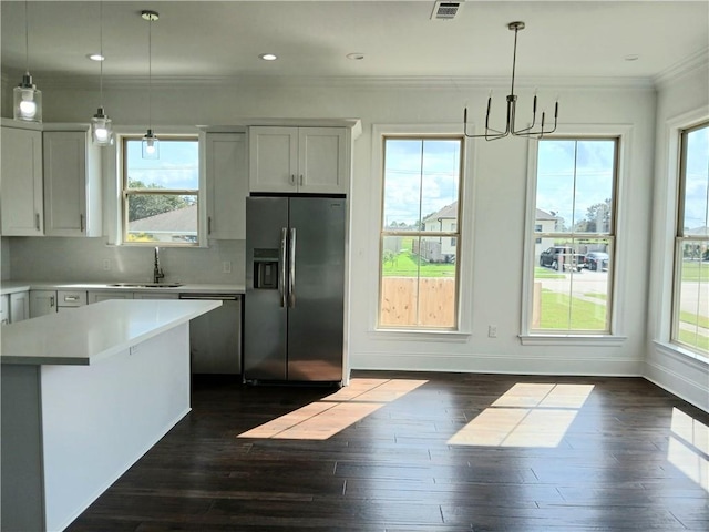 kitchen featuring white cabinetry, appliances with stainless steel finishes, and a healthy amount of sunlight