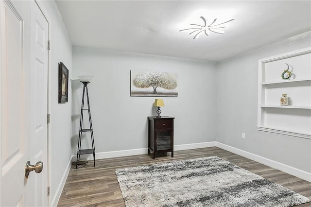 interior space with dark hardwood / wood-style floors and built in features