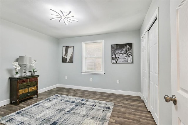 bedroom with a closet and dark hardwood / wood-style flooring