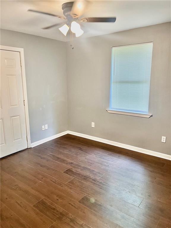 unfurnished room featuring ceiling fan and dark hardwood / wood-style floors