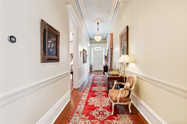 hall with hardwood / wood-style flooring and ornamental molding