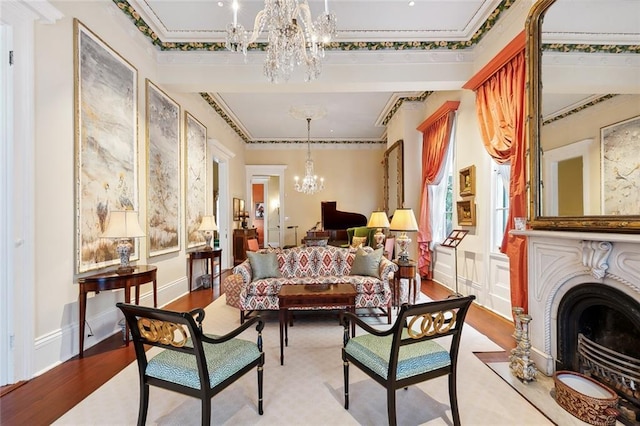 sitting room with crown molding, light hardwood / wood-style flooring, and an inviting chandelier