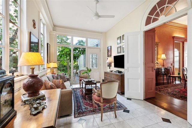 sunroom with ceiling fan and lofted ceiling