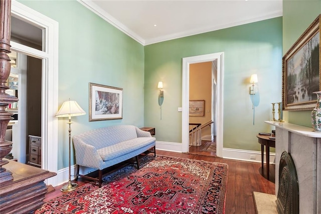 sitting room featuring dark hardwood / wood-style floors and ornamental molding