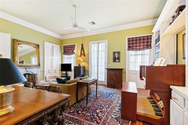 living room featuring ceiling fan and ornamental molding