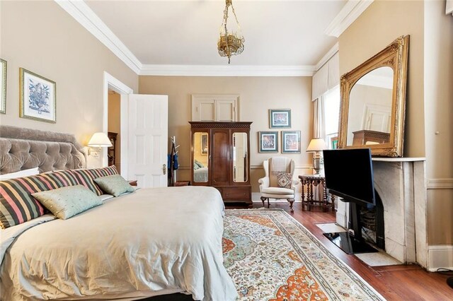 bedroom with dark hardwood / wood-style floors and crown molding