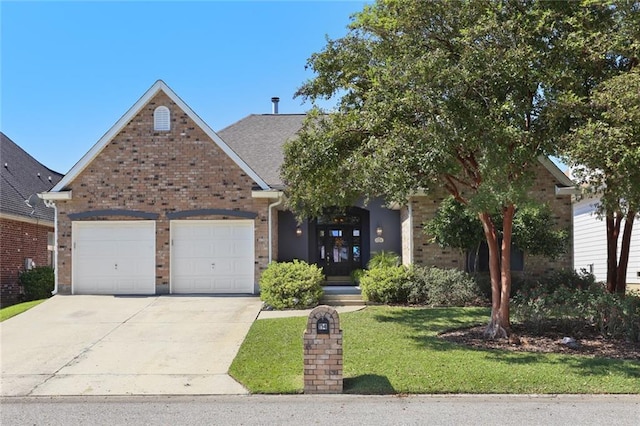 view of front of home with a garage and a front lawn