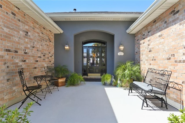 view of exterior entry featuring a patio