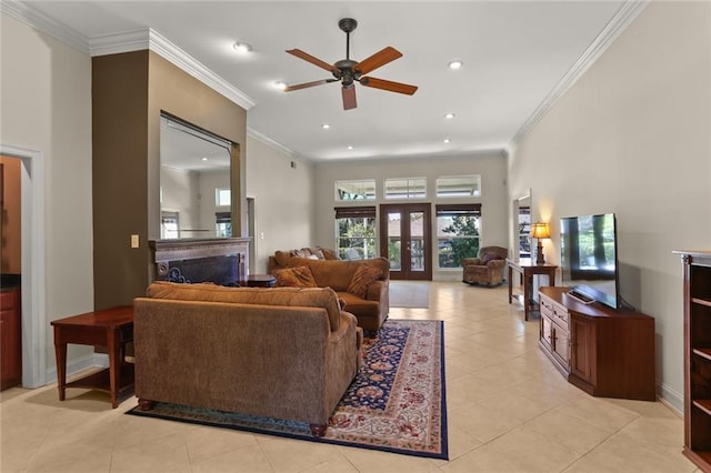 living room featuring ceiling fan, french doors, a high ceiling, ornamental molding, and light tile patterned floors