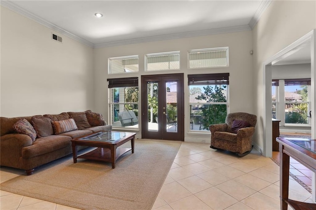 tiled living room with french doors, a towering ceiling, and ornamental molding