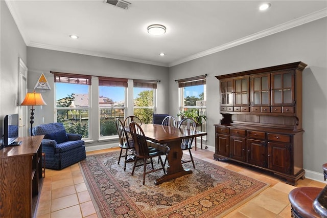 dining room featuring light tile patterned flooring and ornamental molding