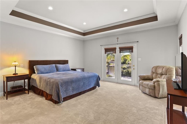 bedroom with access to exterior, light colored carpet, a raised ceiling, french doors, and ornamental molding