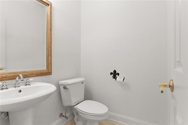 bathroom featuring sink, tile patterned flooring, and toilet