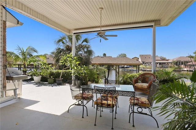 view of patio / terrace with ceiling fan and a water view