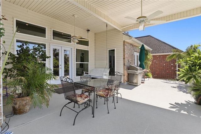 view of patio with area for grilling, ceiling fan, and french doors