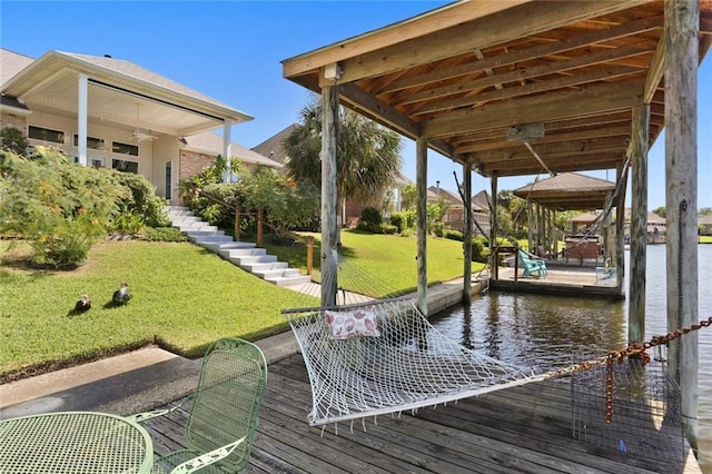 view of dock featuring a lawn and a water view