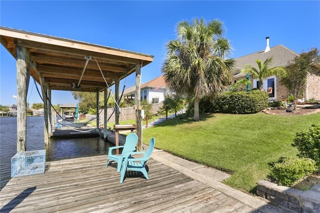 dock area featuring a water view and a lawn