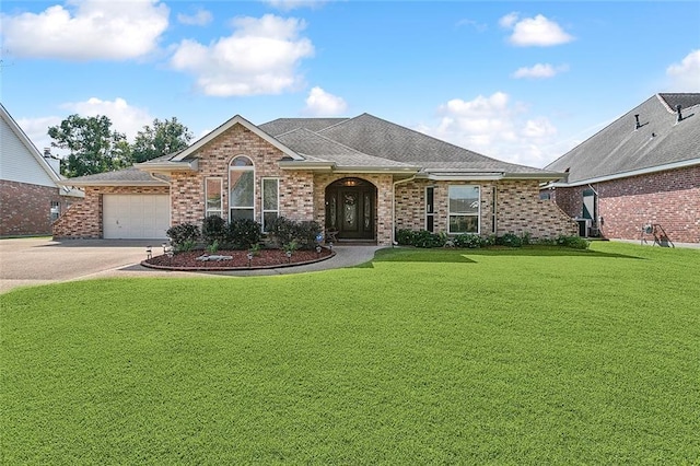 ranch-style house featuring a garage and a front lawn