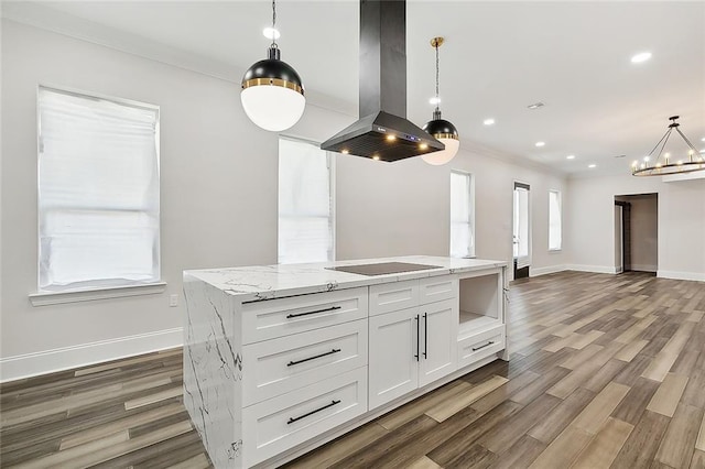 kitchen with pendant lighting, a center island, white cabinets, black electric stovetop, and island range hood