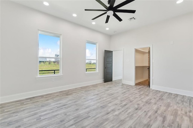 empty room featuring light hardwood / wood-style flooring and ceiling fan