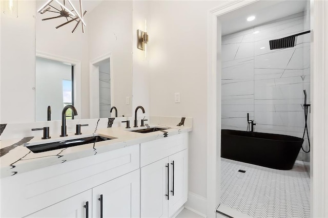 bathroom featuring tiled shower, vanity, and tile patterned floors