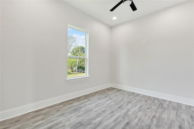 unfurnished room with ceiling fan and light wood-type flooring