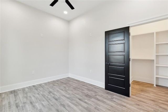 unfurnished room featuring ceiling fan and light wood-type flooring