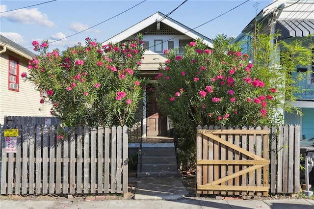 view of front of home featuring fence