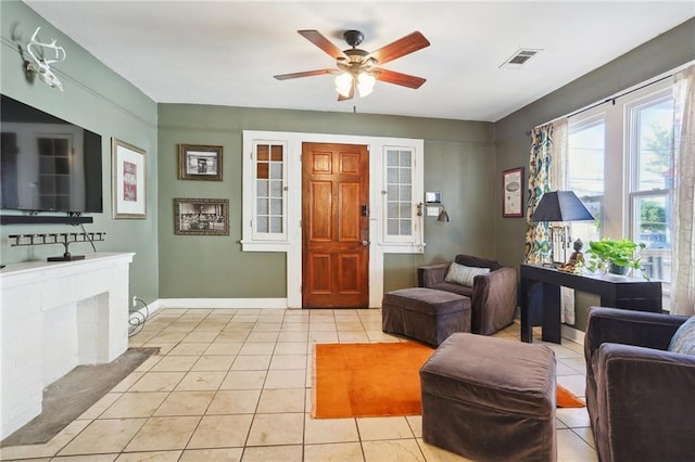 living room with ceiling fan and light tile patterned flooring