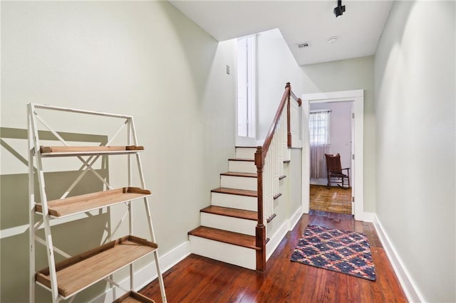 stairs featuring hardwood / wood-style flooring