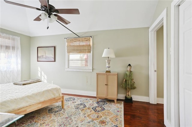 bedroom with a ceiling fan, baseboards, and dark wood-style flooring