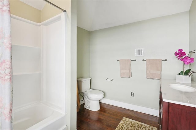 full bathroom featuring sink, shower / bath combo with shower curtain, hardwood / wood-style flooring, and toilet