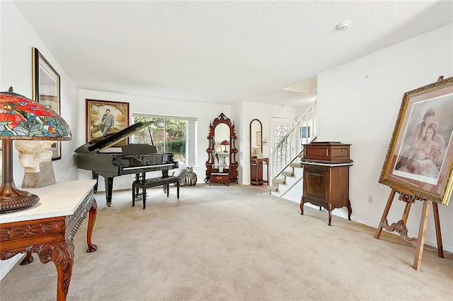 miscellaneous room featuring a textured ceiling and light colored carpet