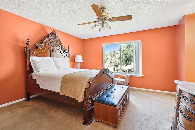 carpeted bedroom with ceiling fan and a textured ceiling