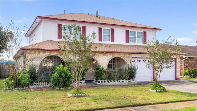 view of front of house with a front yard and a garage