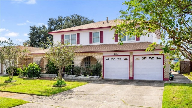 view of front of property featuring a garage and a front yard