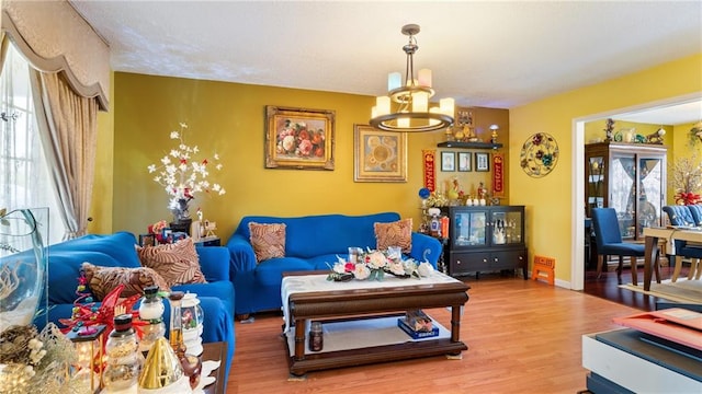 living room featuring wood-type flooring and a chandelier