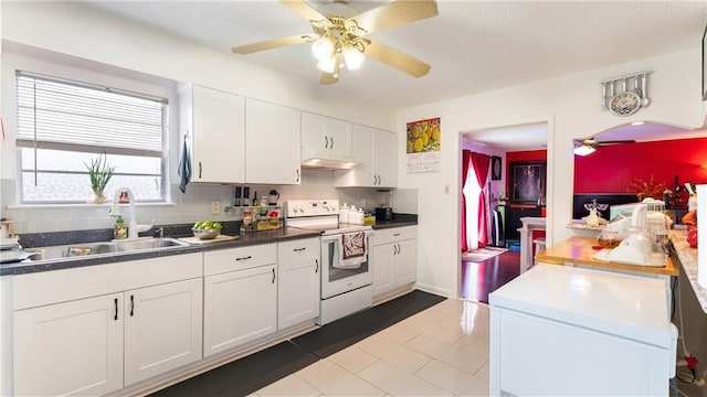 kitchen with ceiling fan, white cabinets, sink, white appliances, and tasteful backsplash